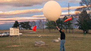 Pat Market releases a weather balloon at CAFNR's South Farm research center.
