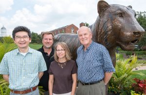 Toshihiko Ezashi (left), Danny Schust (middle), Laura Schulz (middle) and Michael Roberts (right) collaborate on new research to discover the causes of preeclampsia. Photo by Roger Meissen.