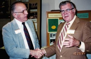 Owen Koeppe, left, shakes hands with Bob Wixom, during part of the festivities for the biochemistry department's centennial celebration in 1994. Phot courtesy of Yvonne Hill and David Wixom.
