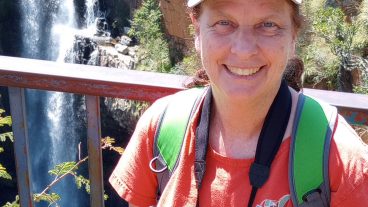 Joanna Whittier headshot in front of a waterfall