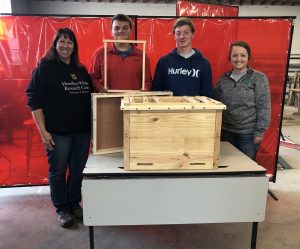 Jennifer Miller (left) worked with Albany High School students to create a horizontal hive for the Hundley-Whaley Research Center.
