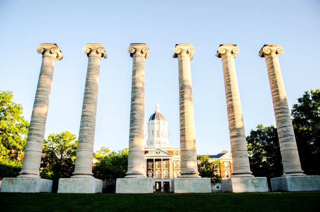photo of the 6 columns framing Jesse Hall on a blue sky day