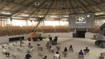 In the show arena section of the Trowbridge Event Center (pictured), a total of 200 students can be in the classroom socially distanced – 145 in the wooden arena seats and 55 in desktop chairs on the concrete floor. The sales arena section will now hold 120 students. The show arena already has a massive projection screen, and the sales arena is complete with projectors and two digital display monitors. Photo by Michelle Enger.