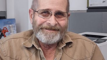 photo of Tracey Mitchell. Man with a gray beard, wearing a brown button-up shirt