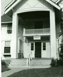 House with large white columns and white siding. Photo taken in 1978, housing the atmospheric science department