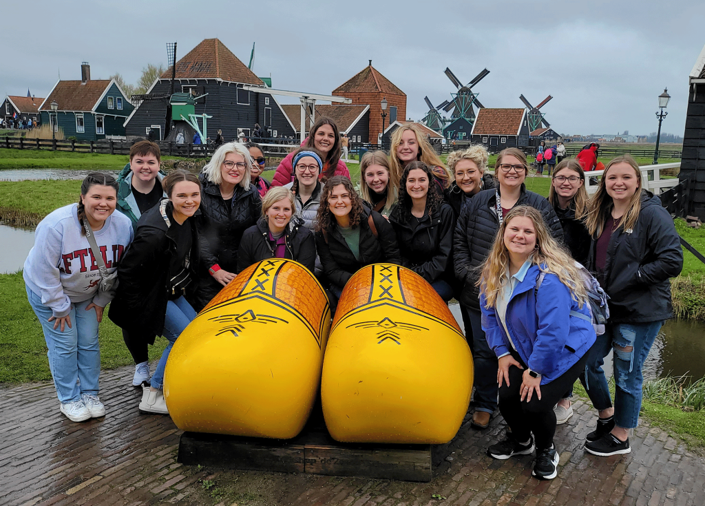 group of students with giant wooden shoes