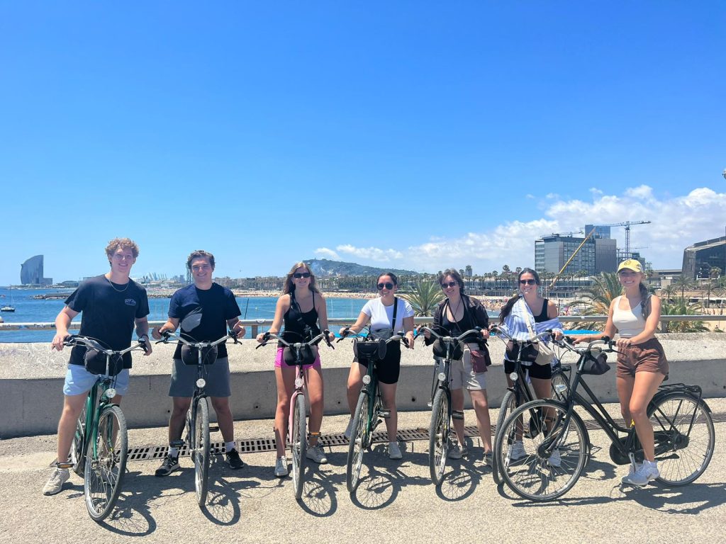 A group of students standing in a line with bicycles.