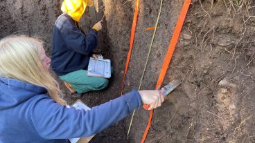 Mizzou soils team members working in a pit of soil.