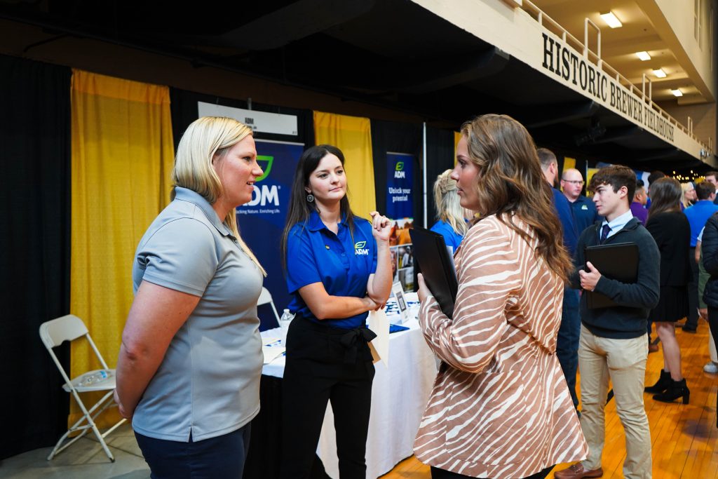 A student talks to employers at the Career Fair. 