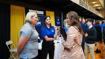 A student talks to employers at the Career Fair.