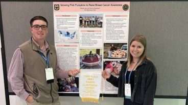 William Lee (left) and fellow plant science and technology student Felicity Guttmann (right) presented a poster about Agronomy Club at a recent conference.