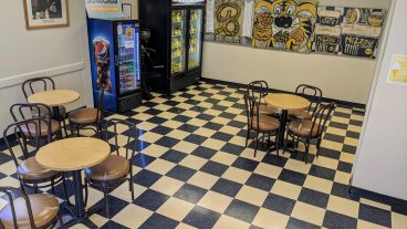 checkerboard flooring with Mizzou themed artwork on the walls