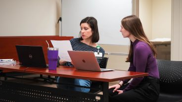 Jennifer Anderson consults with a dietetics student as they make a nutrition plan for their NutriZou client.