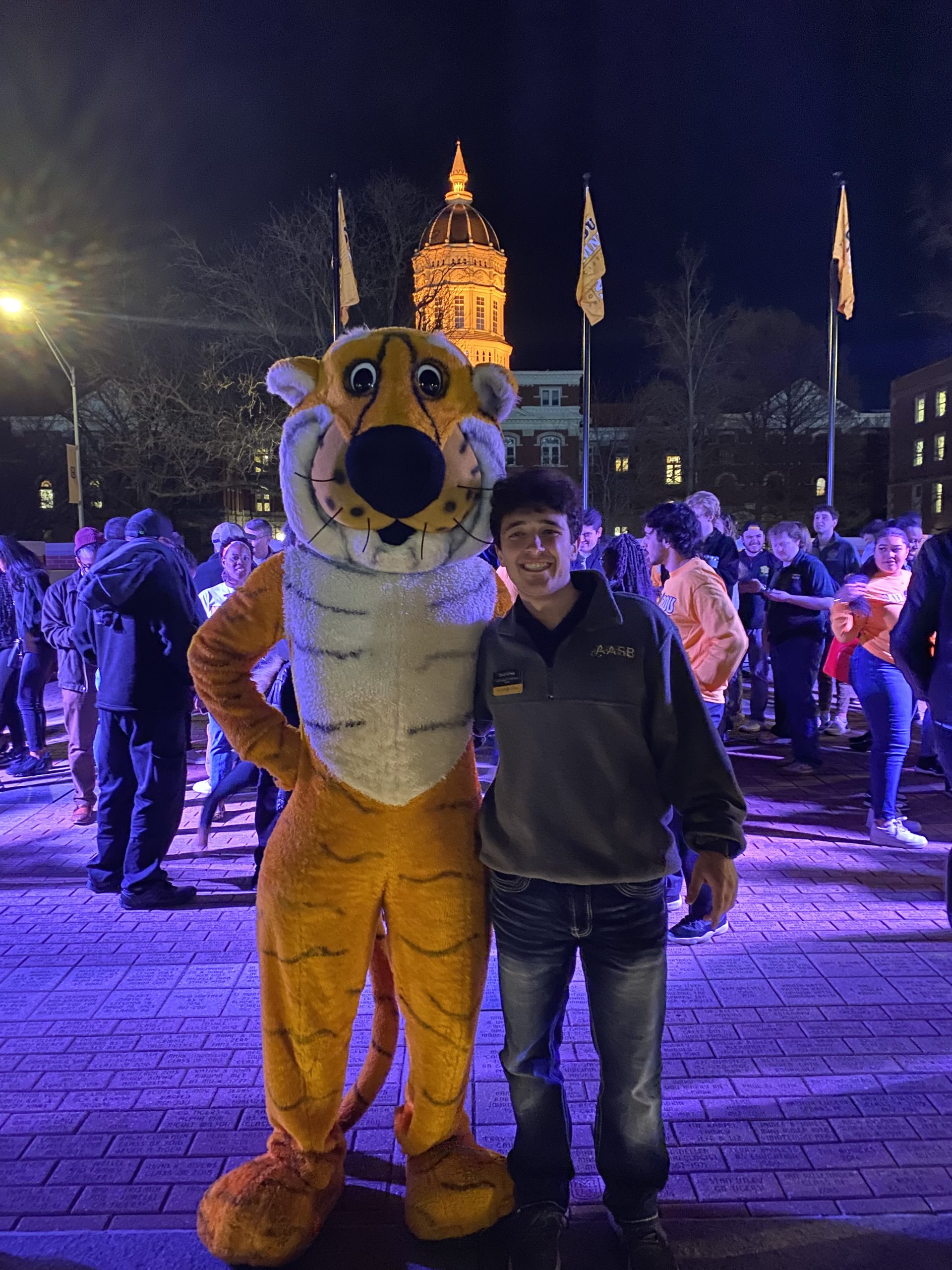 A student poses with Truman the Tiger.
