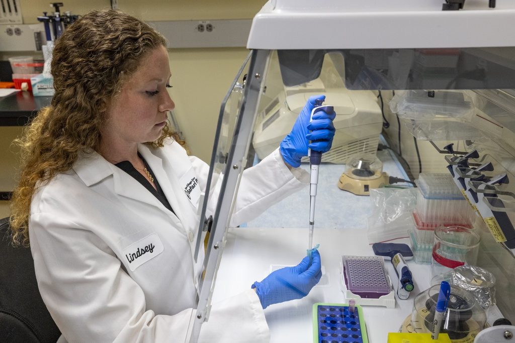 A woman works in a lab. 