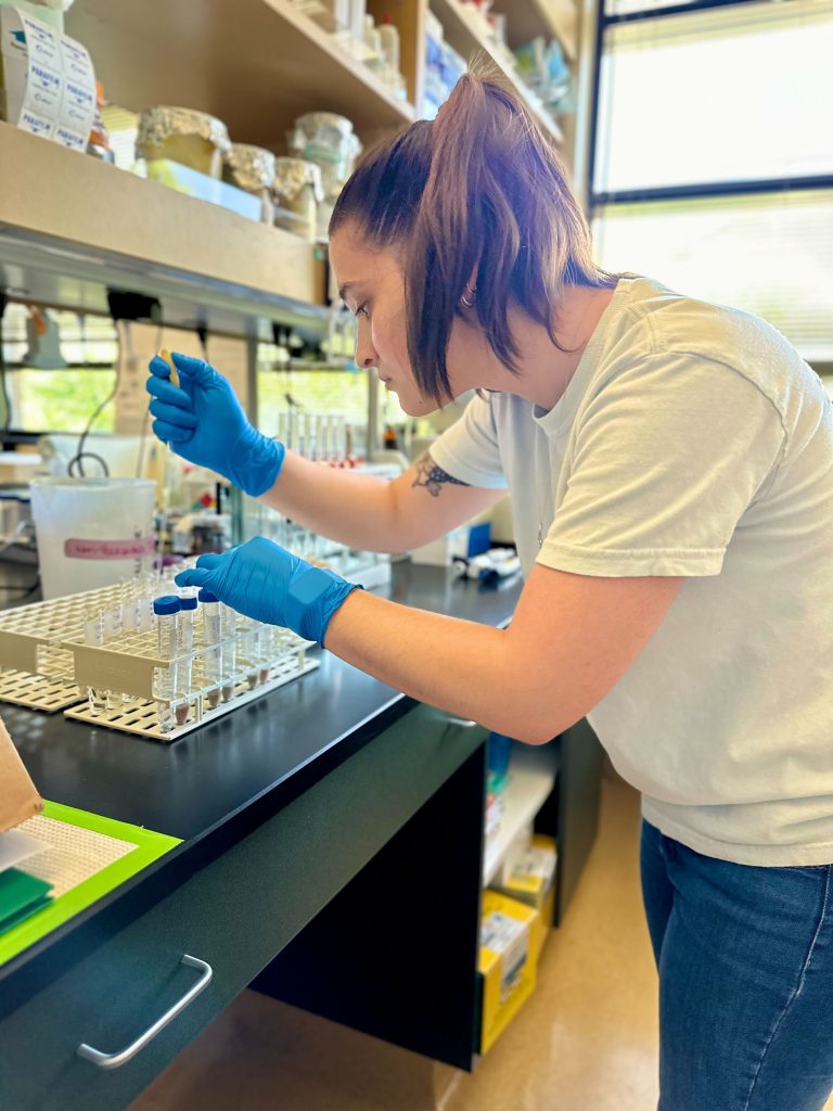 A young woman works in a lab.