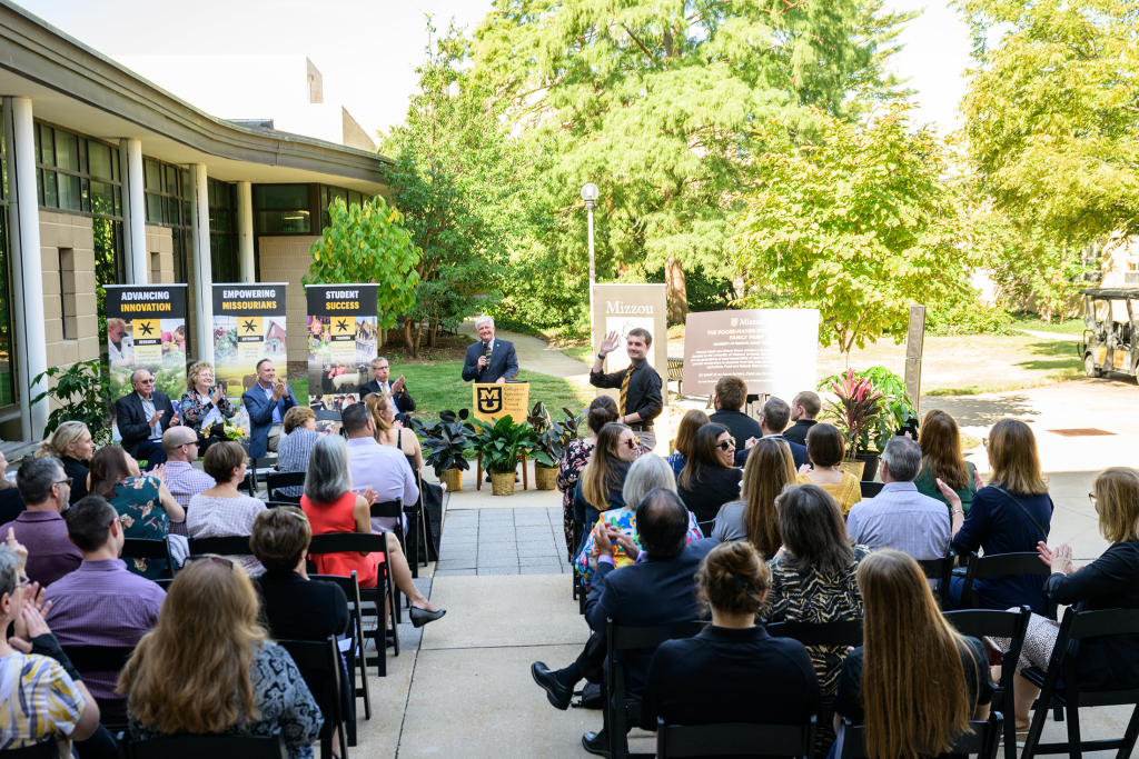 Current CAFNR student and scholarship recipient waves to the crowd at the gift announcement.