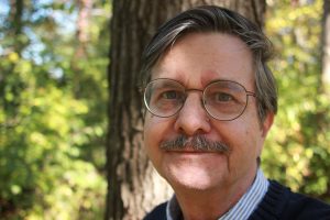 Portrait of David Larsen with a tree in background.