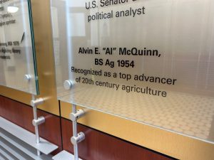 Sign reading: Alvin E. "Al" McQuinn BS Ag '54, Recognized as a top advancer of 20th century agriculture.