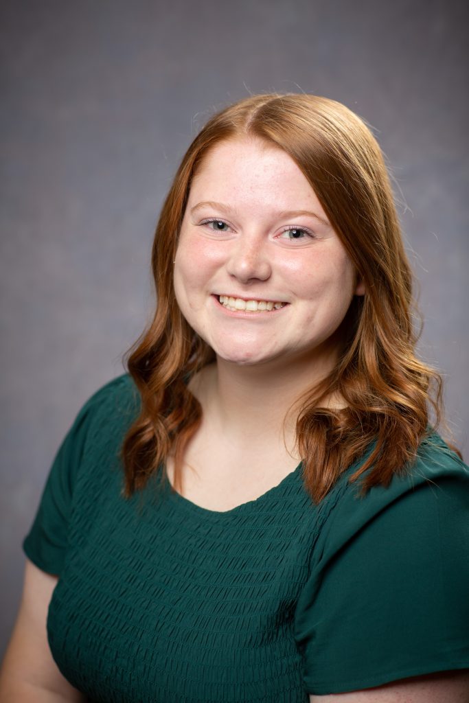 A student poses for a portrait. 