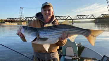 Photo of Rick Relyea holding a striped bass