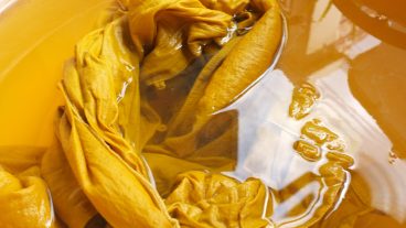 fabric in a yellow dye bath