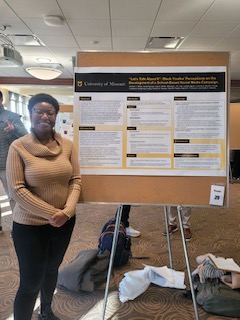 A student with a research poster. 