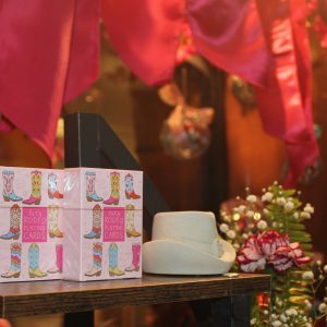 Tiger Garden window display featuring country-themed playing cards and a white cowboy hat.