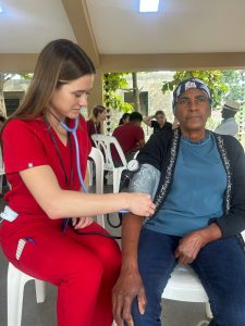 Eva Ruterschmidt takes a patient's blood pressure.