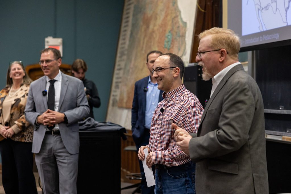 Eric Aldrich smiles and listens as Pat Market, director of SNR, speaks about his Kemper Fellowship.