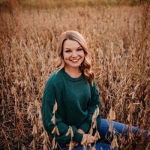Morgan Watkins smiling in a field.