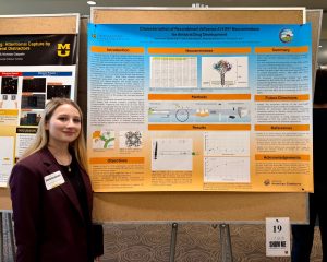 Katherine Spitzmiller stands next to her research poster on American elderberry compounds and their effect on fighting influenza.