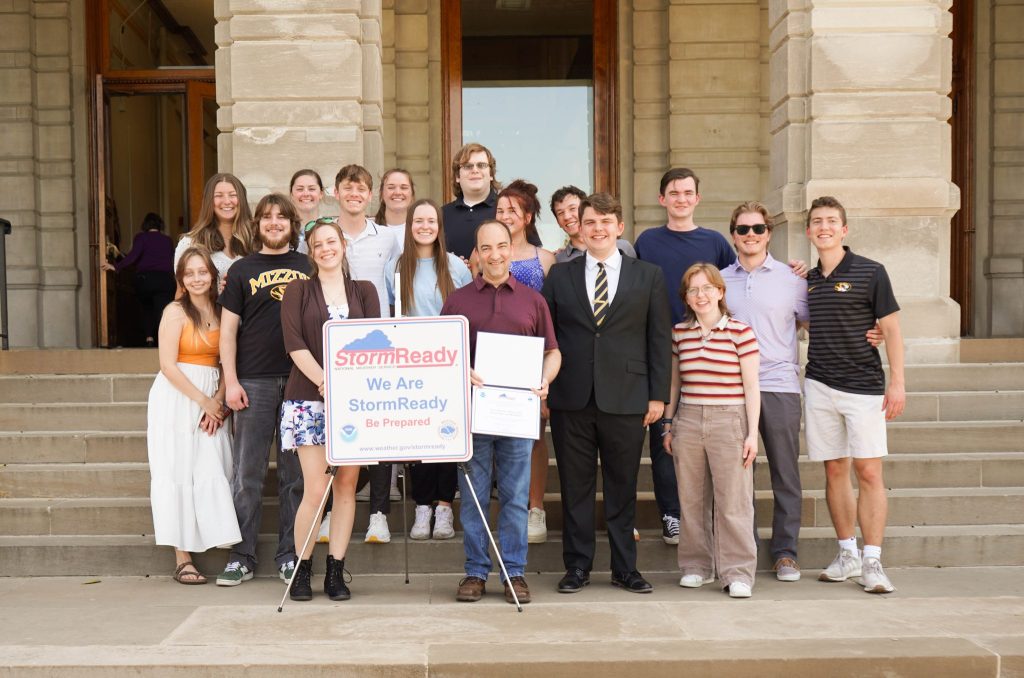 Mizzou Meteorology Club standing outside Jesse Hall with the StormReady certification they helped Mizzou receive.