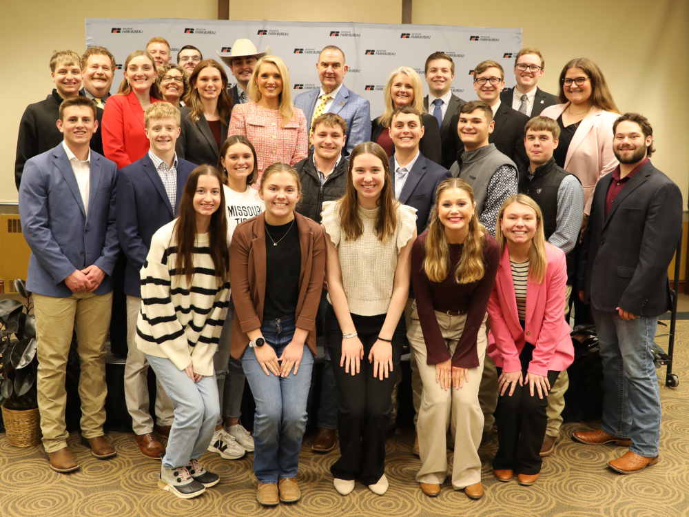 Mizzou Collegiate Farm Bureau members smile in group photo with Tyne Morgan and Gov. Mike Kehoe.