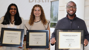 Manisha Muthukarruppan, Carissa Bersche and Mathew Kimaku smile and hold their Awards for Academic Distinction.