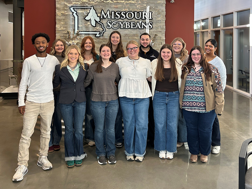 Students in front of Mo Soy sign.