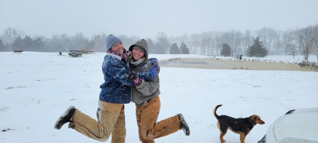 Beth and Bell Foltz smile and hug each other in the snow.