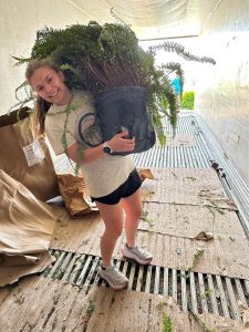 Abbie holding a plant.