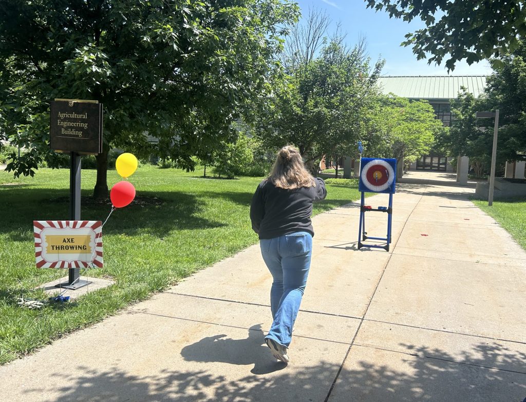 A person throws a dart at a target.