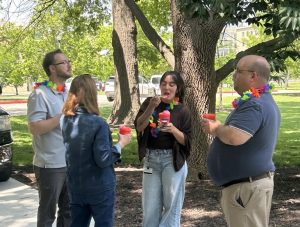 Carnival attendees chat while eating sno cones.