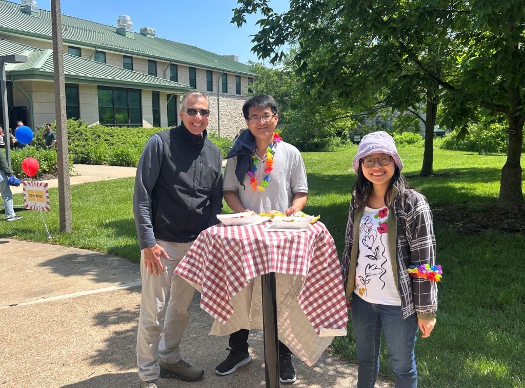 Dean Daubert visits with two attendees.
