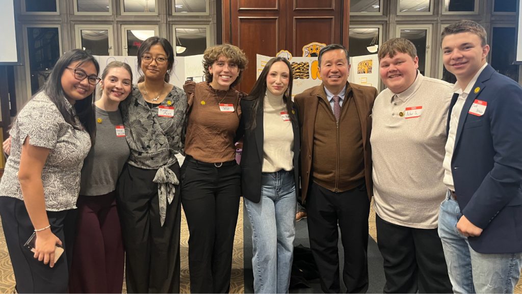 Asher Skelton (second from left) smiles with UM System President Mun Choi (third from left) and other Mizzou students.