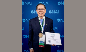 Henry Nguyen with his certificate and medal for induction into the National Academy of Inventors.