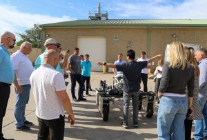 A group looks at a piece of agricultural technology.