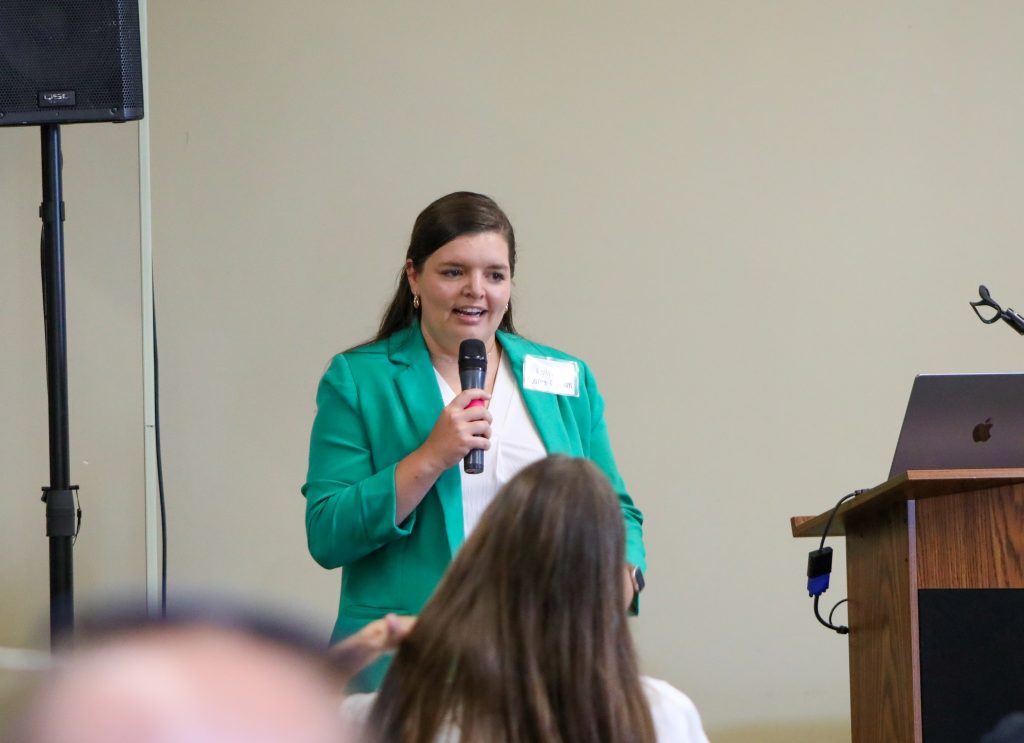 Caitlyn Dozler presenting. 