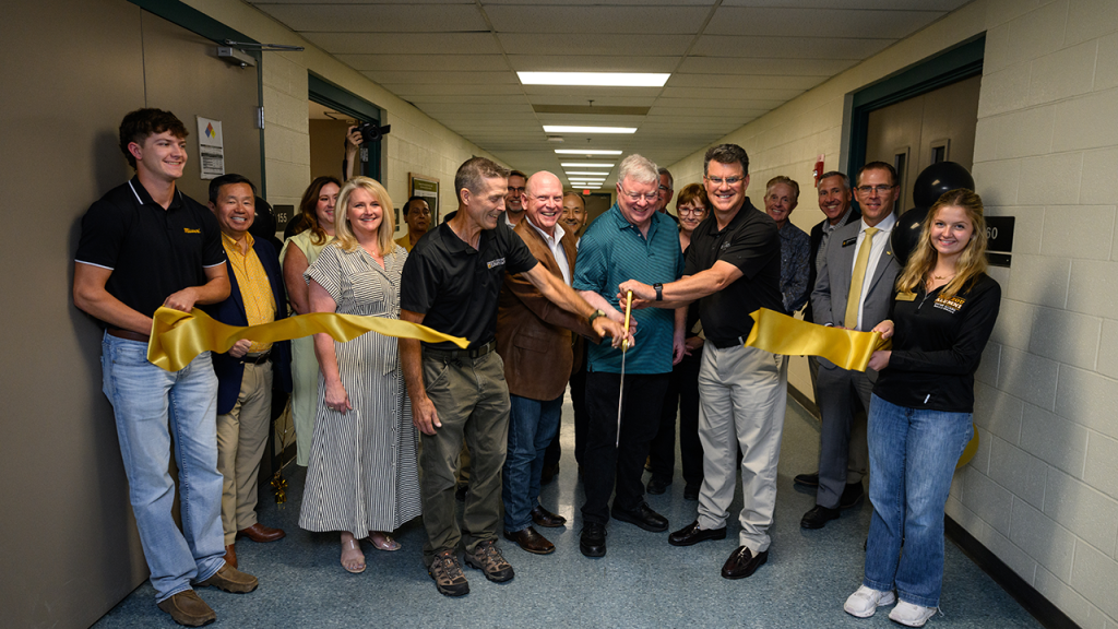 Group cuts ribbon at Fermentation Center.