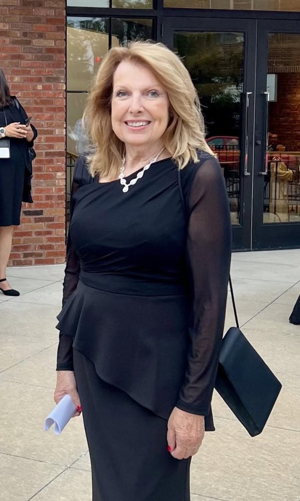 Linda Geist in a black dress outside the Atrium, where the Hall of Fame awards were celebrated.